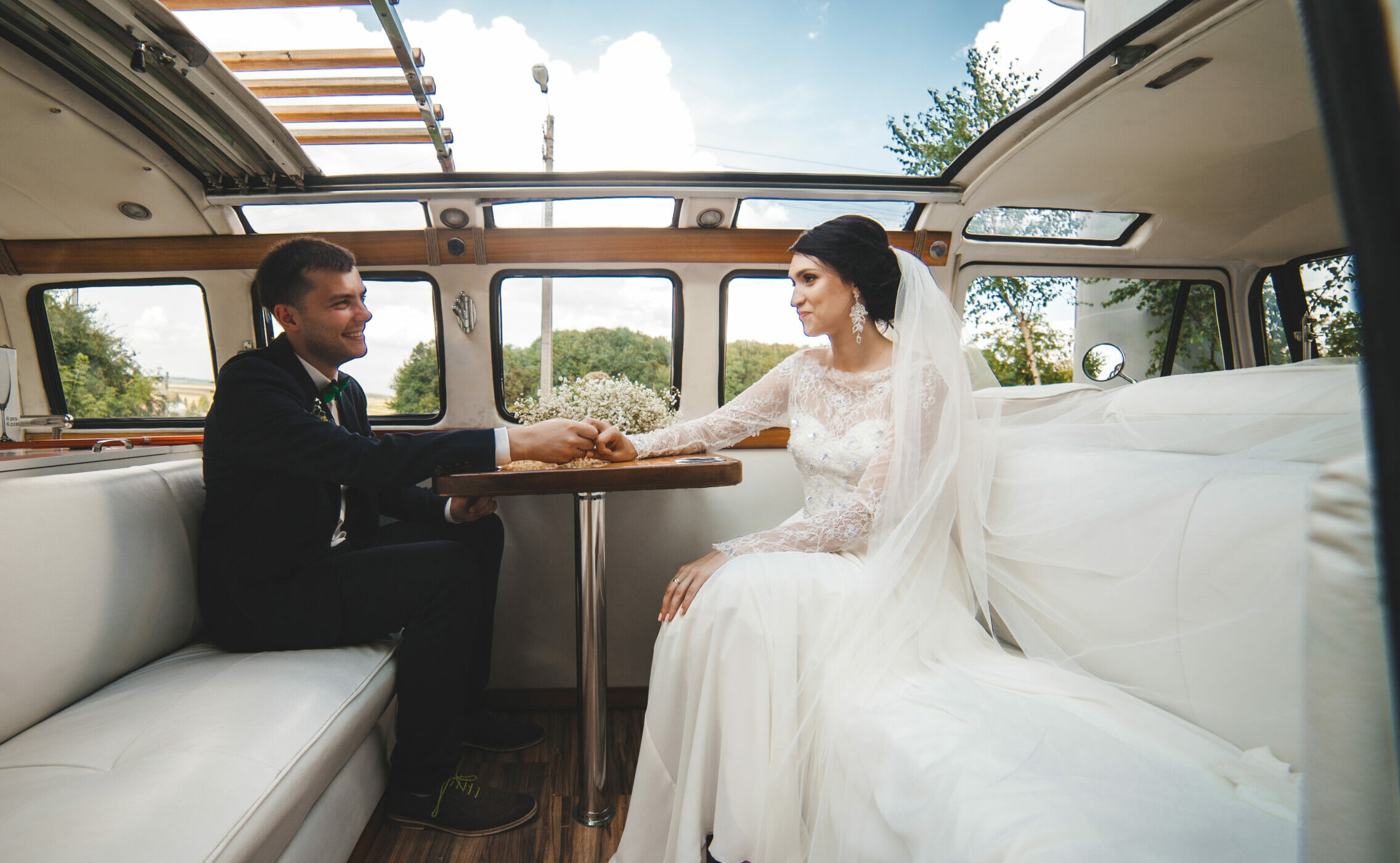 happy-couple-posing-car-after-wedding-Direct-Coach-Hire